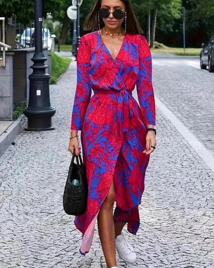 Women's floral V neck midi dress in magenta and blue, front view with long sleeves and wrap skirt