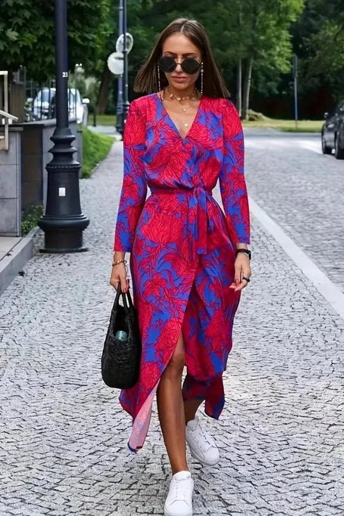 Women's floral V neck midi dress in magenta and blue, front view with long sleeves and wrap skirt