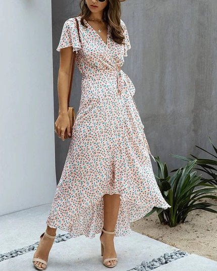 Pink floral V neck midi dress with flutter sleeves, wrap waist tie, and high-low hem
