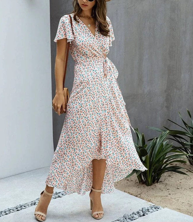 Pink floral V neck midi dress with flutter sleeves, wrap waist tie, and high-low hem