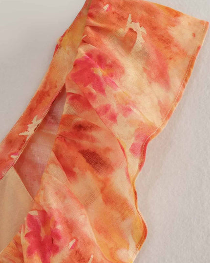Close-up of orange floral maxi dress shoulder strap and sheer fabric texture detail