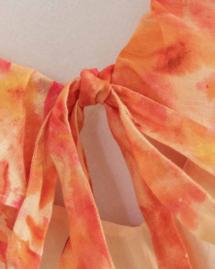Close-up of floral V neck maxi dress tie detail in orange and pink chiffon