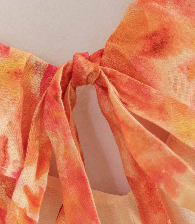 Close-up of floral V neck maxi dress tie detail in orange and pink chiffon
