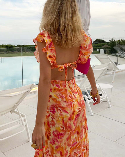 Back view of orange floral V neck maxi dress with open back tie and flutter sleeves