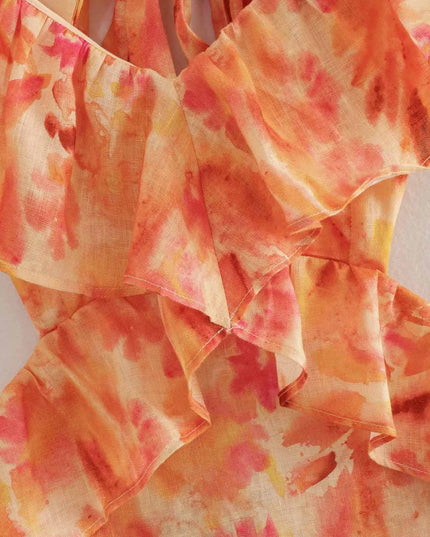 Close-up of orange floral V neck maxi dress ruffle neckline and layered bodice detail