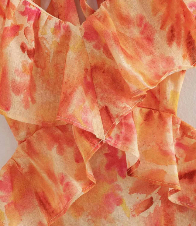 Close-up of orange floral V neck maxi dress ruffle neckline and layered bodice detail
