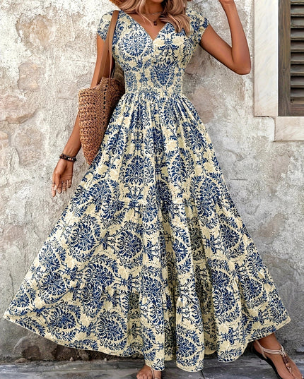 Women's summer floral V-neck shirred maxi sundress in light beige with blue floral print and cap sleeves.