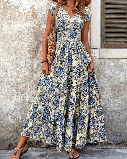 Front view of a women's elegant blue floral V-neck maxi sundress with a comfortable shirred top.