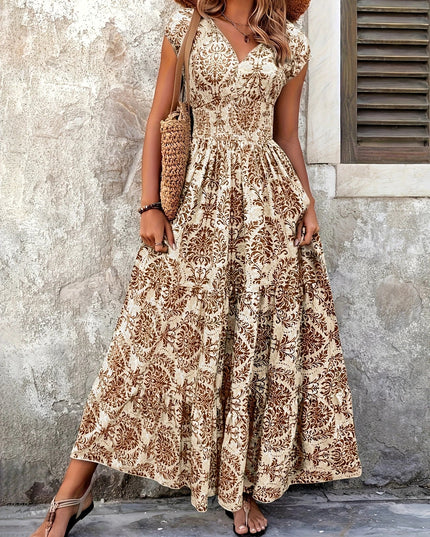 Full length view of a women's elegant brown floral V-neck maxi sundress with a shirred top.