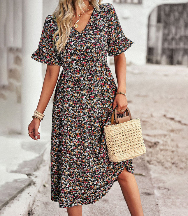 Black floral midi dress with v-neck worn with straw tote bag