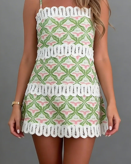 Front full view of summer mini dress with geometric floral pattern and white eyelet trim