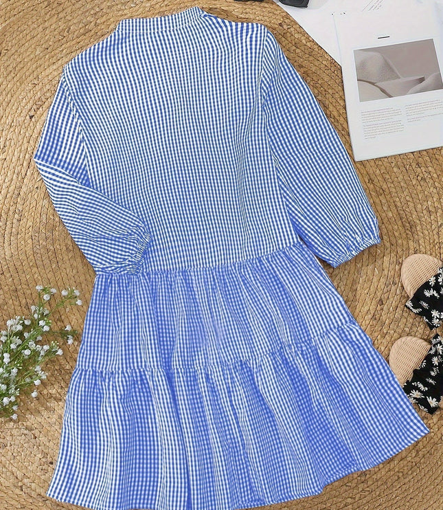 Blue gingham V neck mini dress laid flat with tiered skirt and long puff sleeves