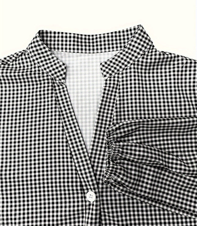 Close-up of black gingham V neck mini dress with collar, button front, and sleeve cuff