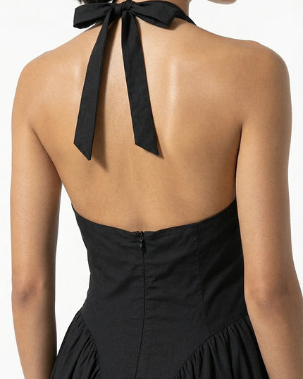 Back view of black halter midi dress with tied neck bow and open back detail