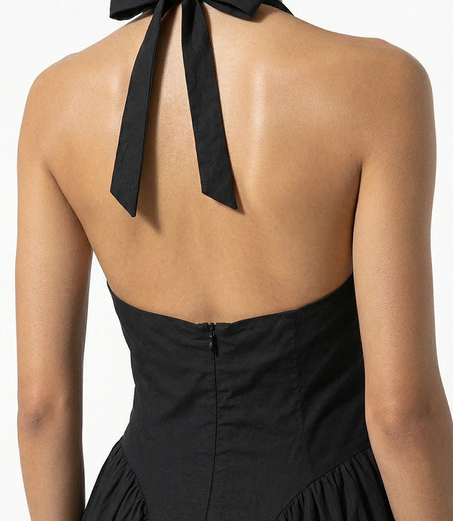Back view of black halter midi dress with tied neck bow and open back detail