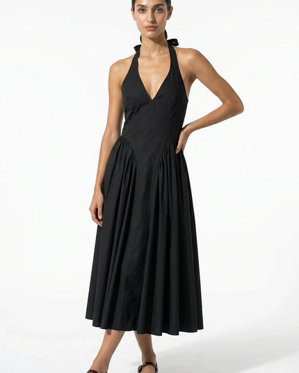 Black halter midi dress with deep V neckline and full pleated skirt, front view