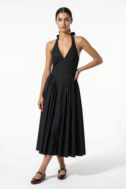 Black halter midi dress with deep V neckline and full pleated skirt, front view