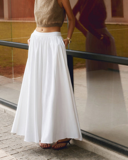 Front view of white pleated maxi skirt with high waistband and soft full-length drape
