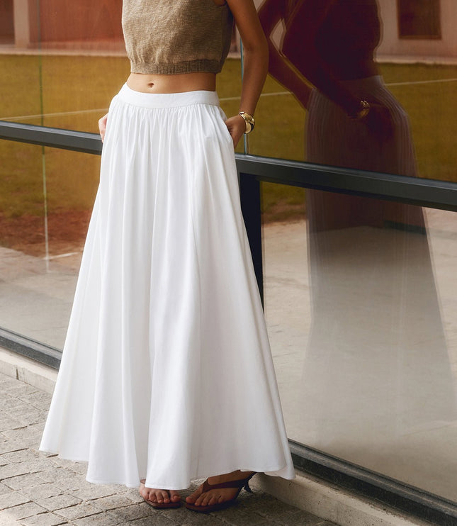 Front view of white pleated maxi skirt with high waistband and soft full-length drape