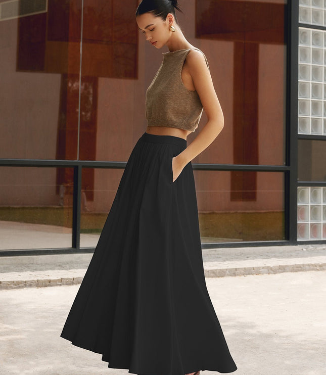 Back view of white pleated maxi skirt with high waist and smooth flowing fabric