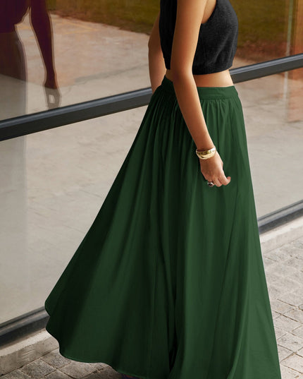 Back view of black pleated maxi skirt with high waistband and long flowing hem
