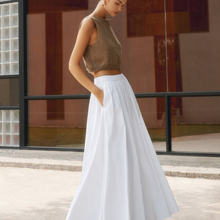 White high waisted pleated maxi skirt with flowing A-line silhouette and side pockets