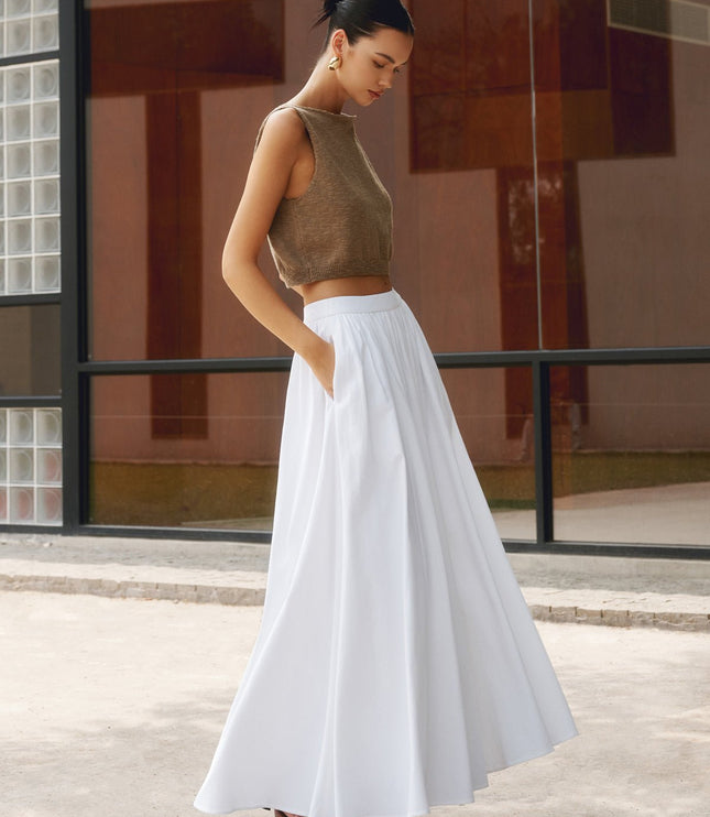 White high waisted pleated maxi skirt with flowing A-line silhouette and side pockets