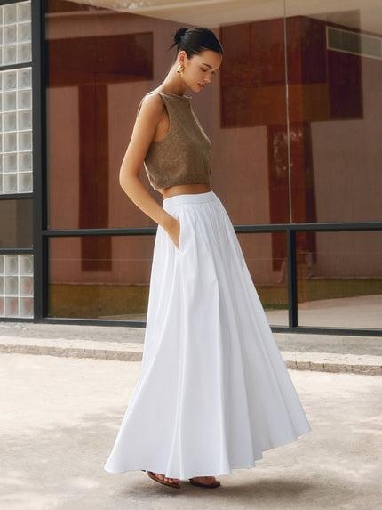 White high waisted pleated maxi skirt with flowing A-line silhouette and side pockets