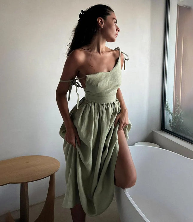 Side view of sage green summer linen dress with one-shoulder tie detail and gathered skirt