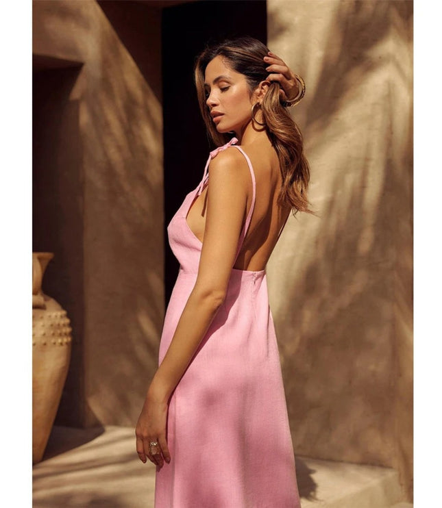 Side view of pink linen maxi dress with open back and tie shoulder straps