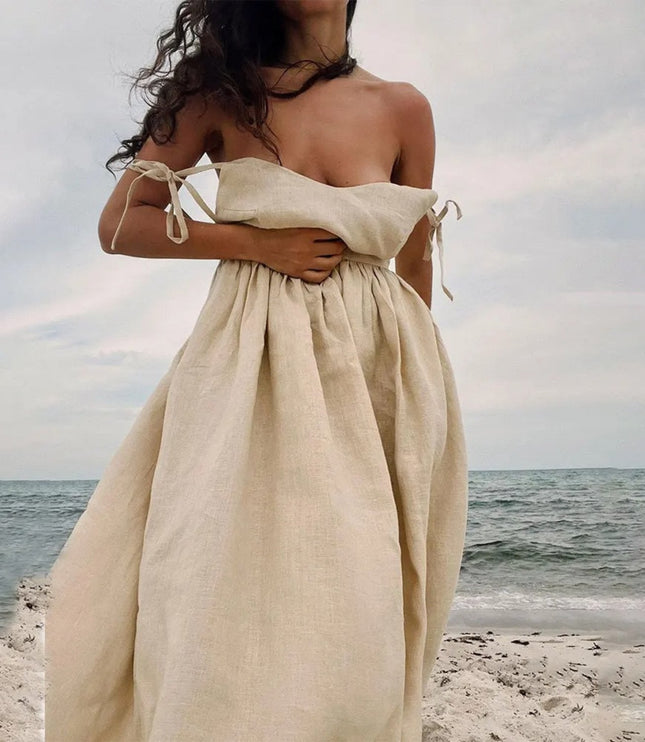 Beige strapless linen maxi dress with tied side straps and loose flowing summer skirt