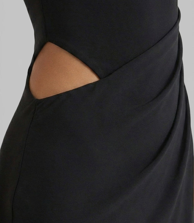 Close-up of black summer maxi dress showing side cut out and draped waist detail