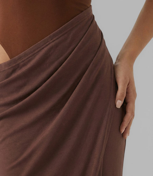 Close-up of brown summer dress showing draped waist and side cut out detail