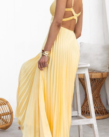 Back view of yellow pleated summer dress with open back straps and maxi skirt