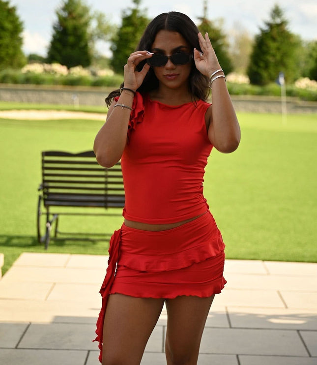 Red summer dress with ruched waist and ruffle mini skirt, front view with sunglasses