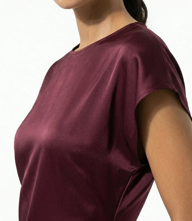Close-up of burgundy satin midi dress showing sheen and cap sleeve detail