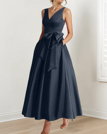 Navy blue sleeveless A-line satin maxi dress with bow accent