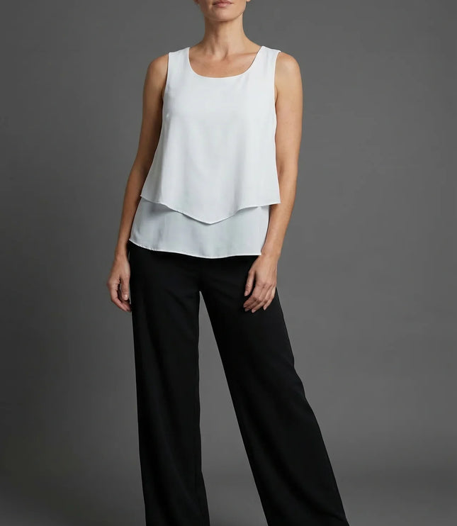White sleeveless layered top with black wide leg pants in a minimalist summer co ord set