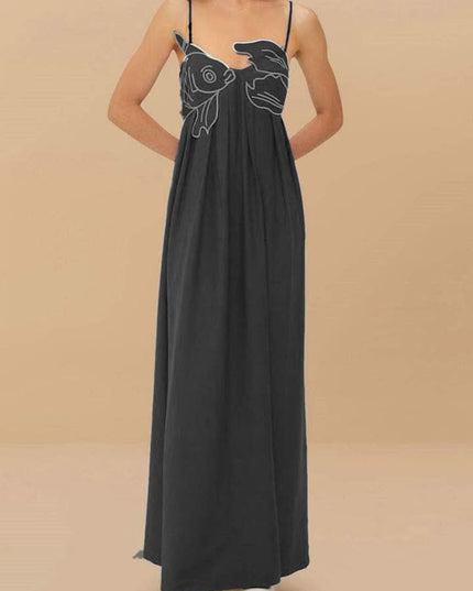 Black fish print maxi dress shown from the back with thin straps and long drape