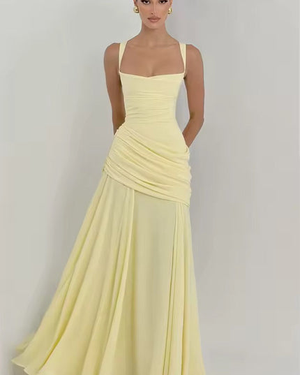 Full-length pale yellow formal maxi dress with asymmetrical wrap and flowing skirt