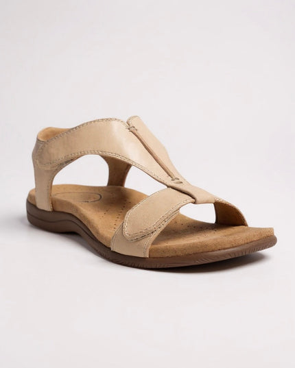 Beige leather t-strap sandal with perforated comfort footbed and hook-and-loop fastener