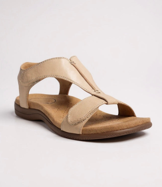 Beige leather t-strap sandal with perforated comfort footbed and hook-and-loop fastener