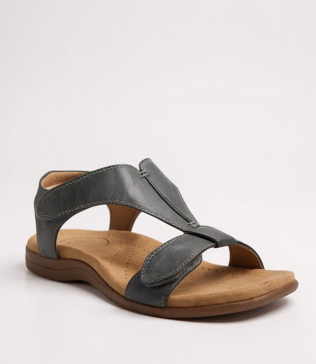 Charcoal gray leather t-strap sandal with cushioned sole and decorative top stitching