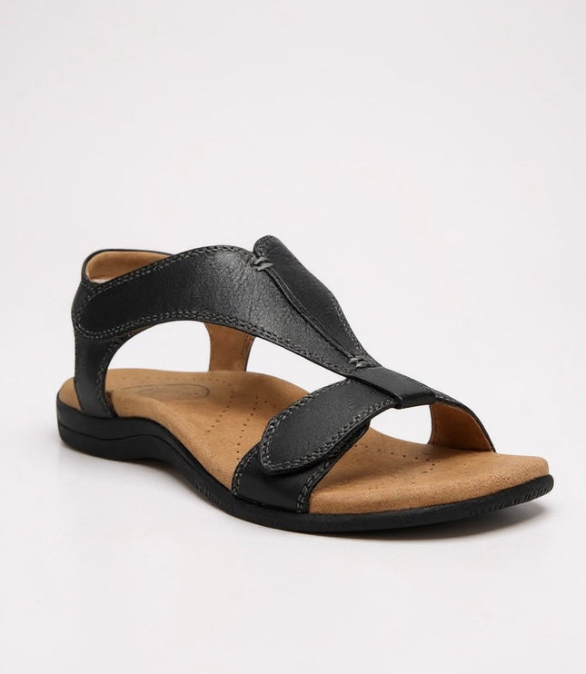 Black leather t-strap sandal with cushioned cork footbed and stitched details