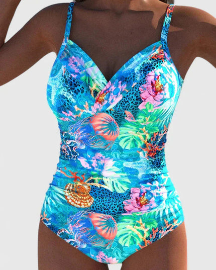 Women's tropical printed one-piece swimsuit with tie-back in bright blue with colorful coral and floral motifs, front view