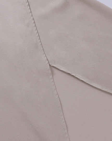 Close-up of the high side slit on the champagne V-neck maxi slip dress, the inner lining and careful tailoring.