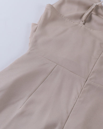Back view detail of the beige women's maxi slip dress, showing the zipper and adjustable spaghetti straps.
