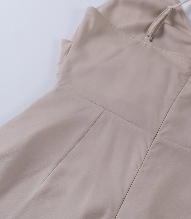 Back view detail of the beige women's maxi slip dress, showing the zipper and adjustable spaghetti straps.