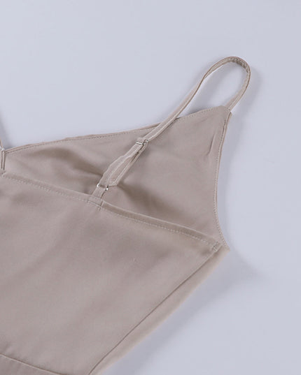 Close-up back detail of a champagne V-neck maxi slip dress, showing the adjustable spaghetti straps and zipper closure.