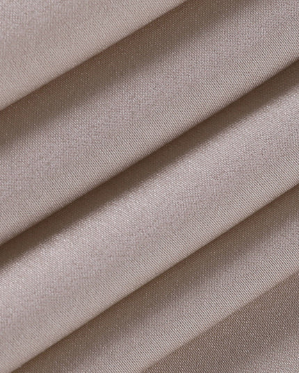 Detailed view of the smooth, champagne-colored satin fabric of the women's maxi slip dress, showing its luxurious texture.